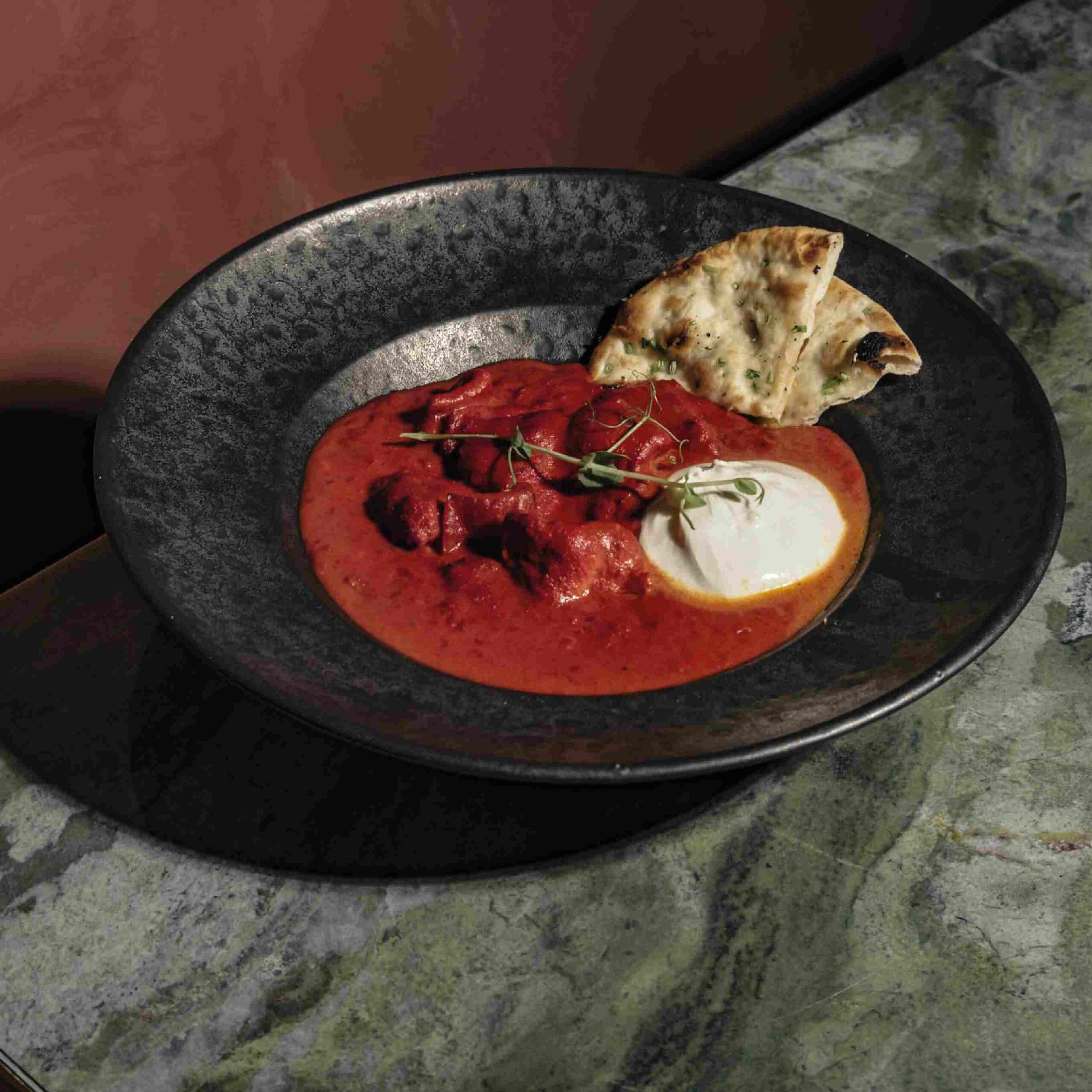 Fusion curry topped with burrata and served with naan bread at Ruby Rays Malta