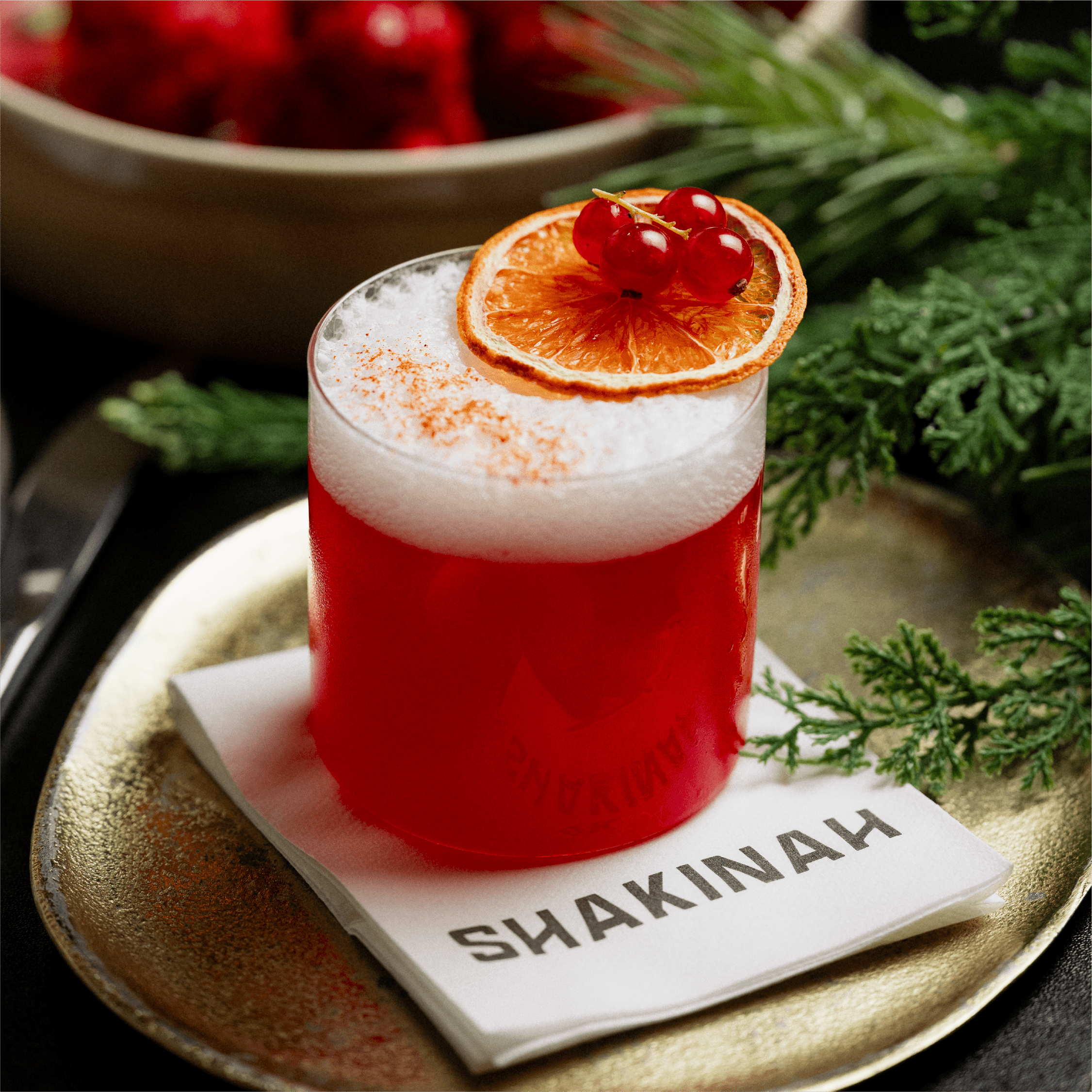 Festive dining area at Shakinah Restaurant in Malta featuring warm golden lights, lush greenery, and elegant table settings.